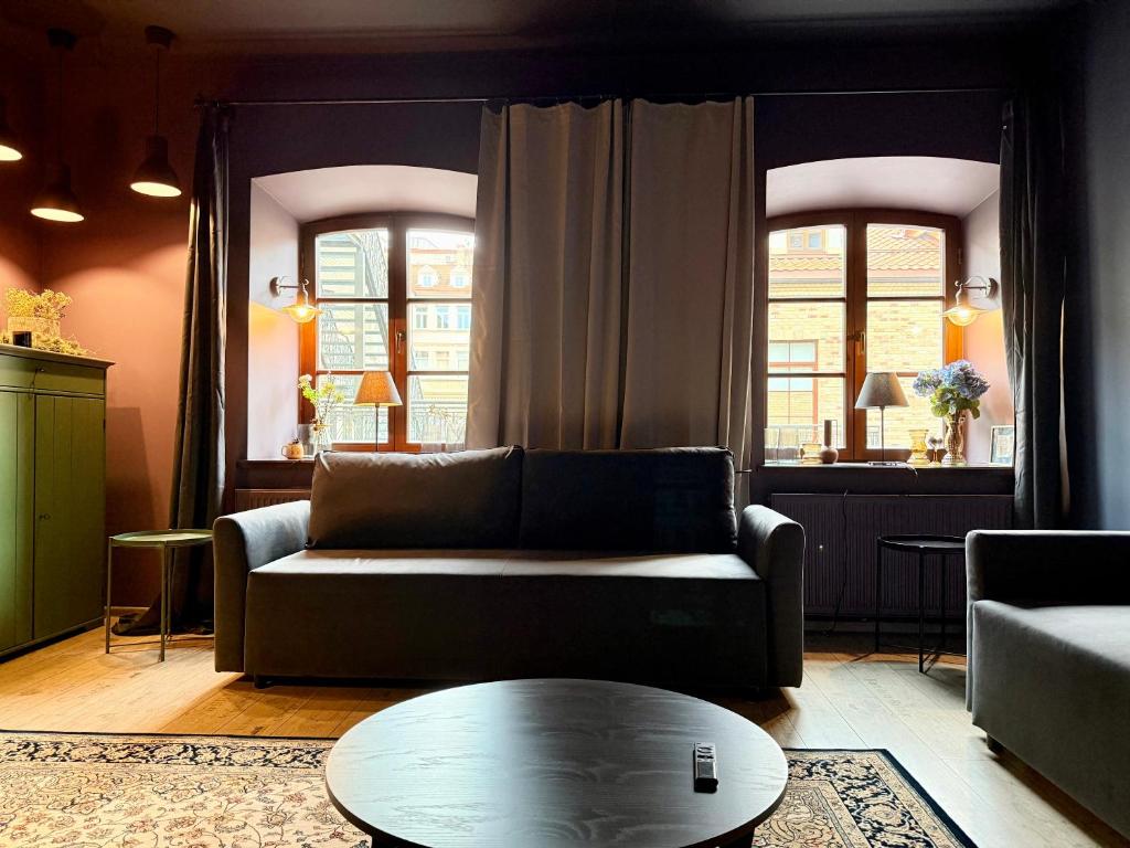 a living room with a couch and a table at Traku14 Old Town Yoga Studio in Vilnius