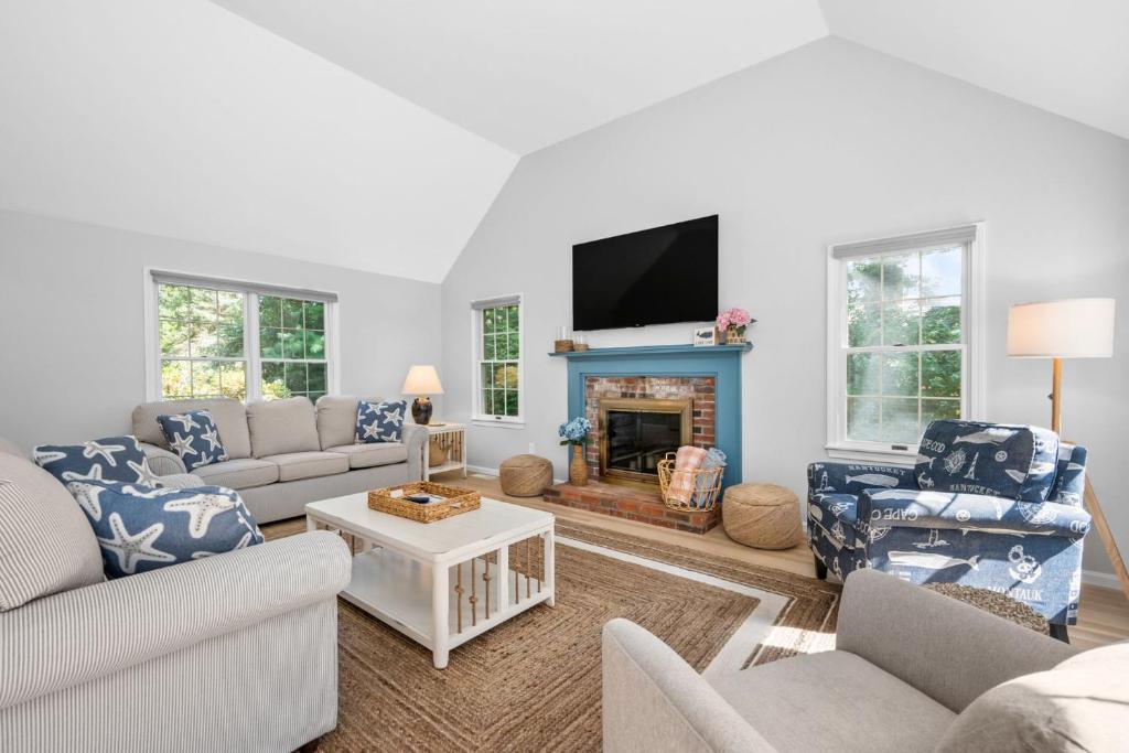 a living room with couches and a fireplace at On Cape Time – Family Friendly Relaxing Escape in Osterville