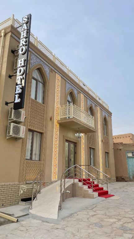 a building with a sign on the side of it at Sahro Hotel Khiva in Khiva