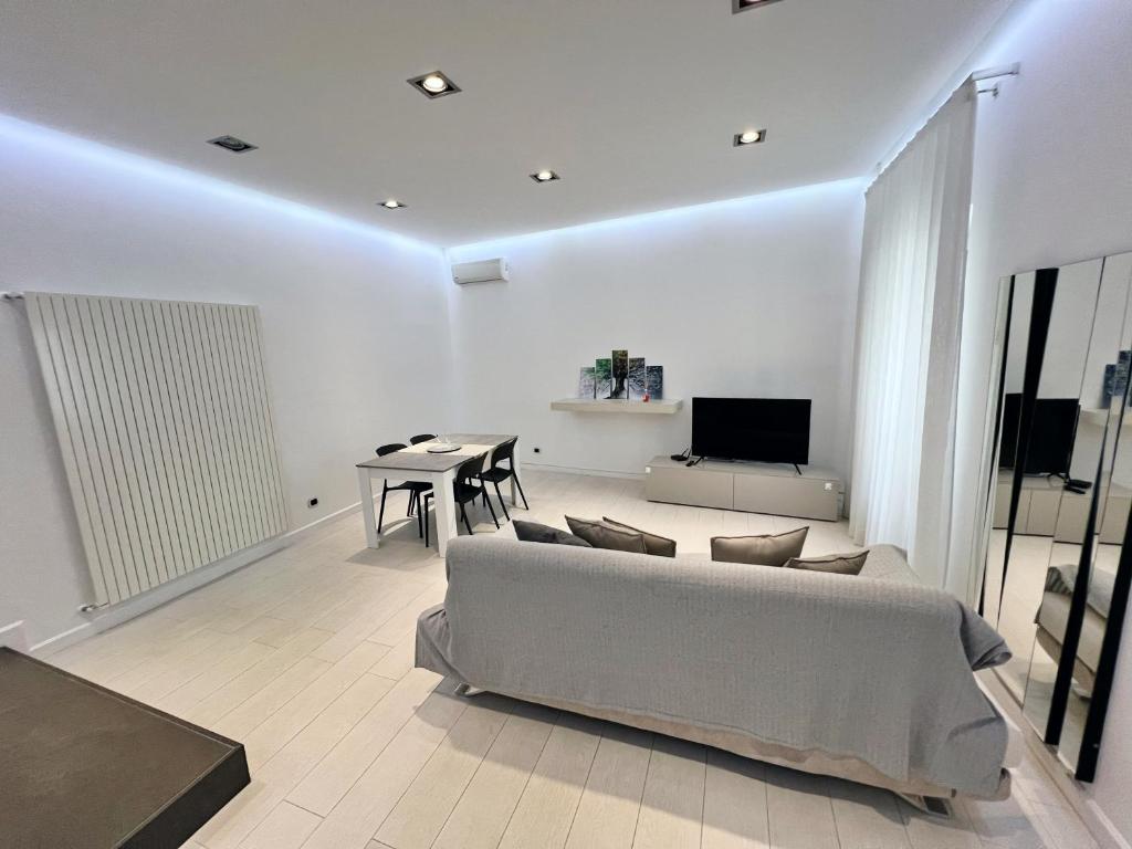 a living room with a couch and a table at AragonApartment in Santa Maria a Vico