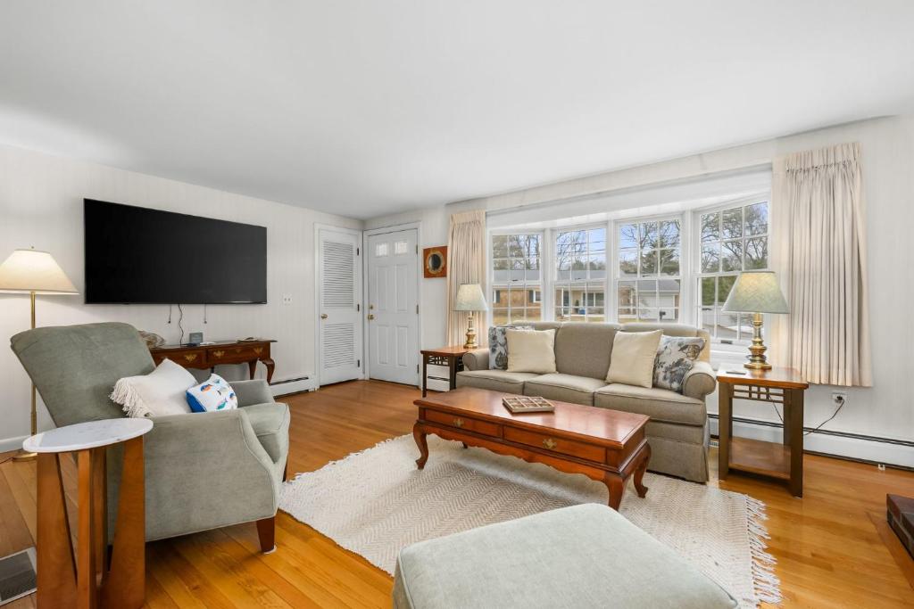 a living room with a couch and a tv at Cozy Cape Escape Near Beaches Dining in Centerville