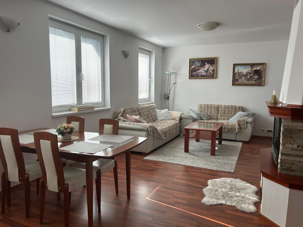 a living room with a table and a couch at Dom pri Veži in Košice