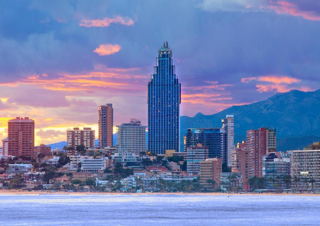 a view of a city skyline with a sunset at Gran Hotel Bali in Benidorm