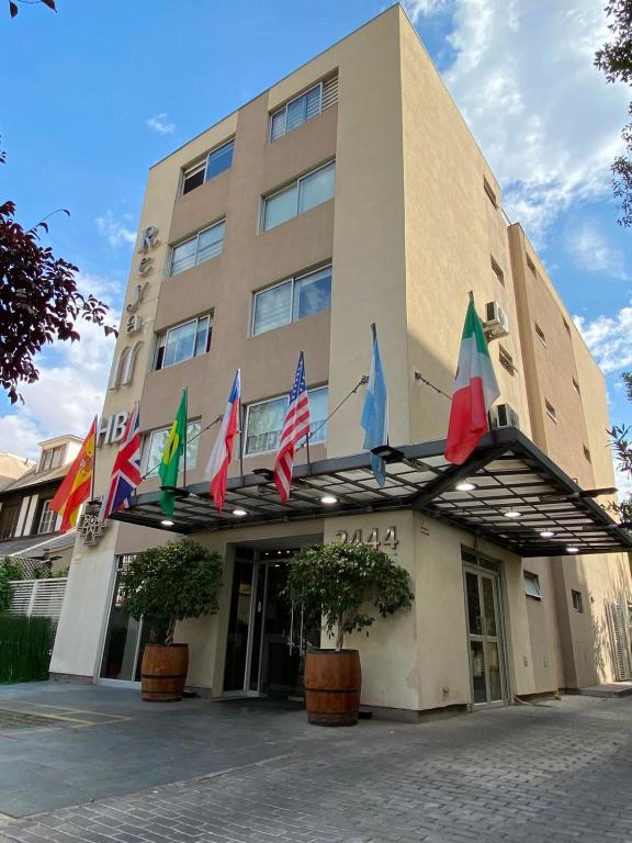 a hotel with flags on the front of it at Hotel Boutique Reyall in Santiago