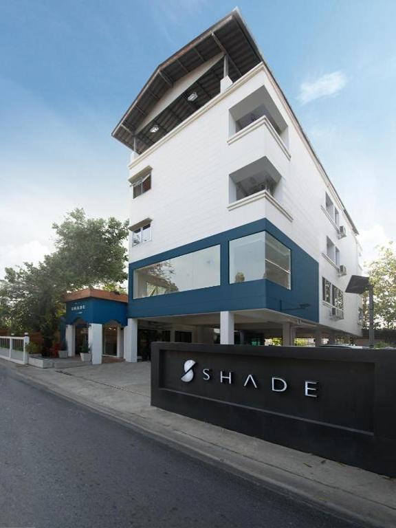 a large white building with a sign in front of it at Shade House - Bitec Bangna in Bangkok