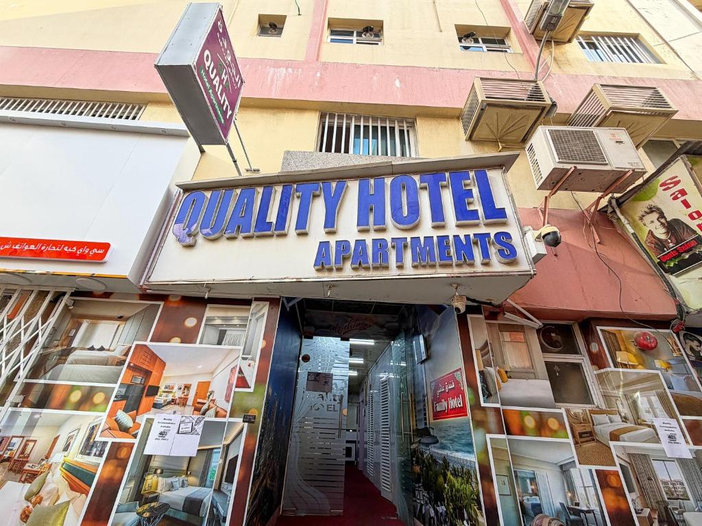 a building with a sign that readsquality hotel apartments at Quality Hotel Apartments in Sabkhah