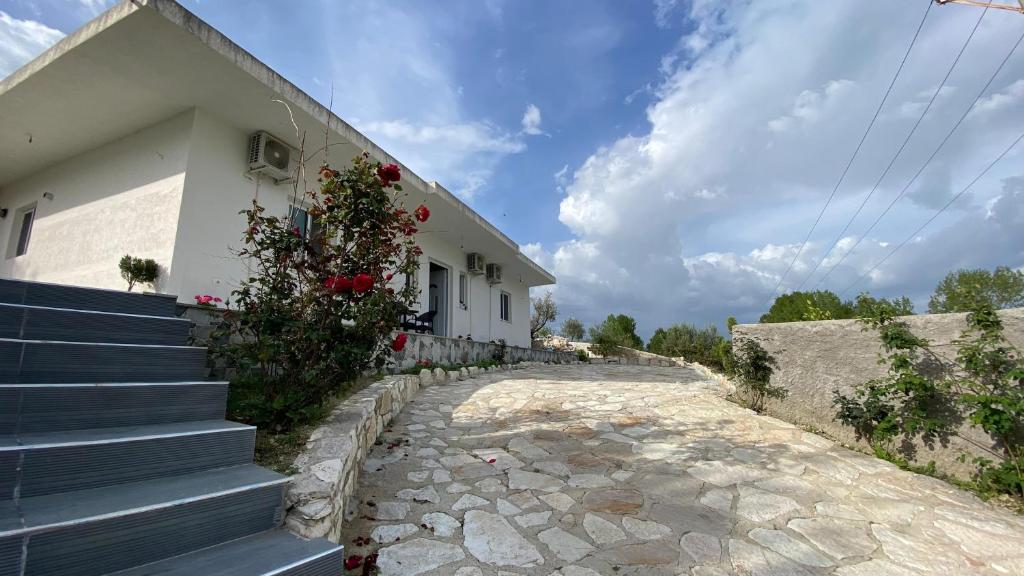 a house with stairs next to a building at Damiano House in Sarandë
