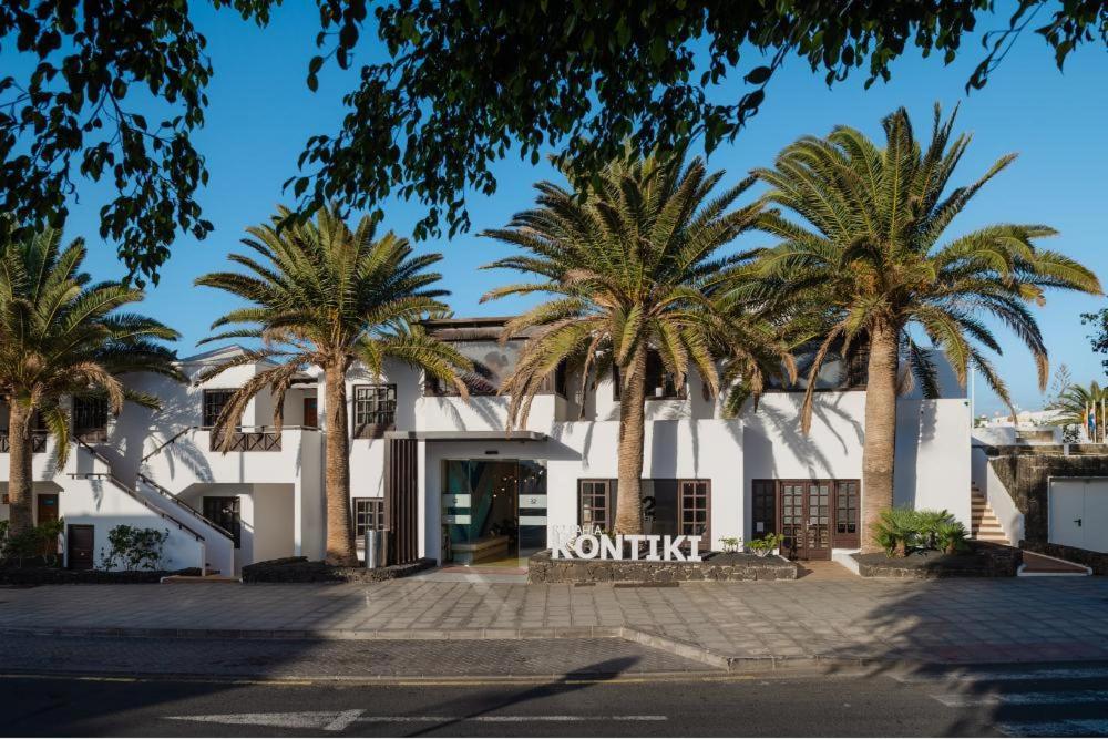 a building with palm trees in front of it at R2 Bahia Kontiki in Puerto del Carmen