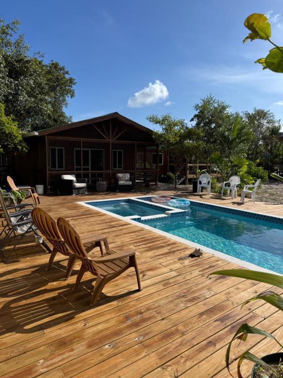a deck with chairs next to a swimming pool at Tortuga Amarilla 1 in Maya Beach