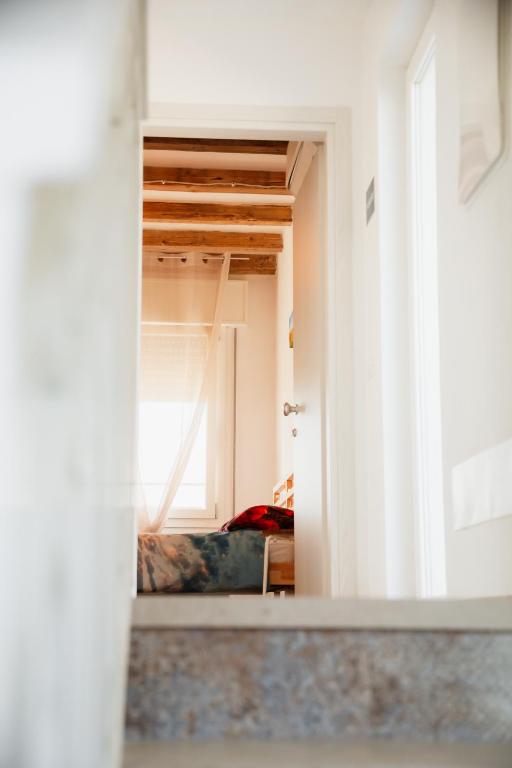 an open door to a room with a bedroom at Ca' Foega rooms in Chioggia