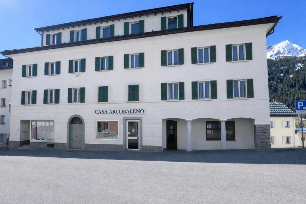 a large white building with the words case majordomo at Casa Arcobaleno in Airolo