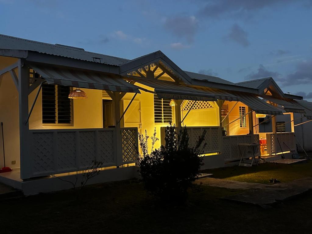 a house with awnings on the front of it at Les lodges couleur caraïbes in Saint-François