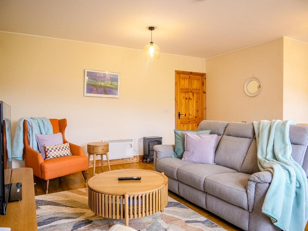 a living room with a couch and a table at Central Dingle Stay in Dingle