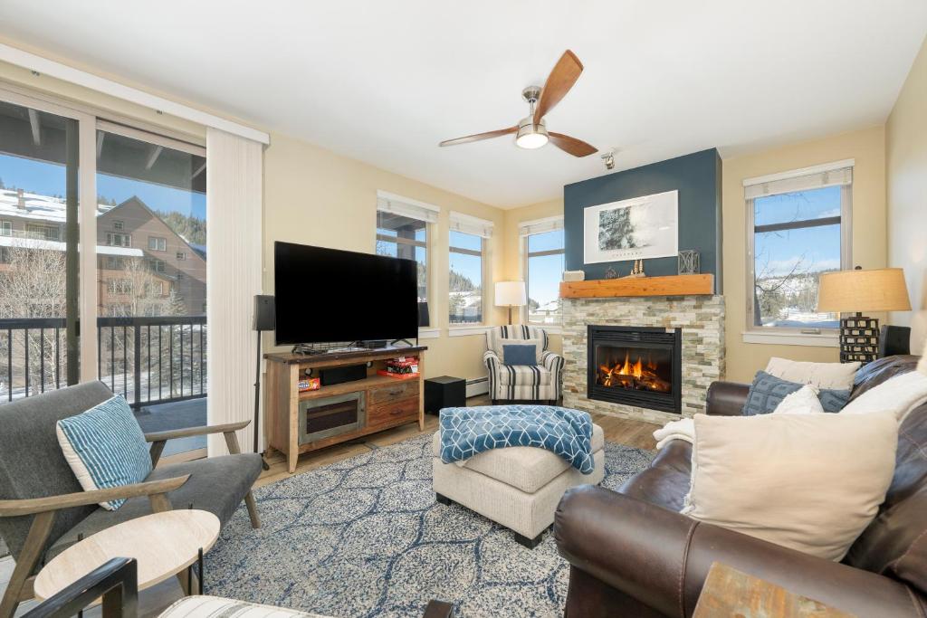 a living room with a tv and a fireplace at Fraser Crossing 3302 in Winter Park