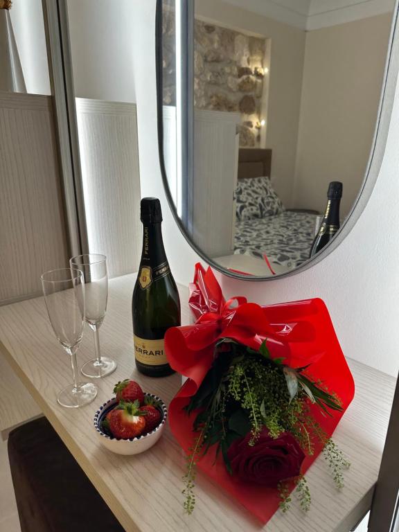 a table with a bottle of wine and a glass at Romantico bilocale ad Ortigia in Syracuse