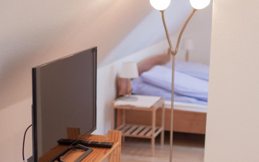 a tv sitting on a table next to a bed at Luv Lee Duhnen 09 in Cuxhaven