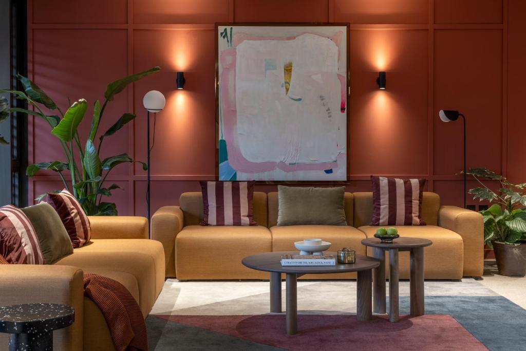 a living room with two couches and a table at The Pepper Mill - Campus Residence in Edinburgh