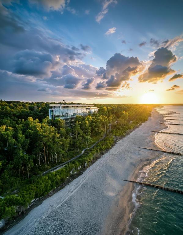 an aerial view of the beach at sunset at Baltic Jet Luxury Aparthotel in Ustronie Morskie