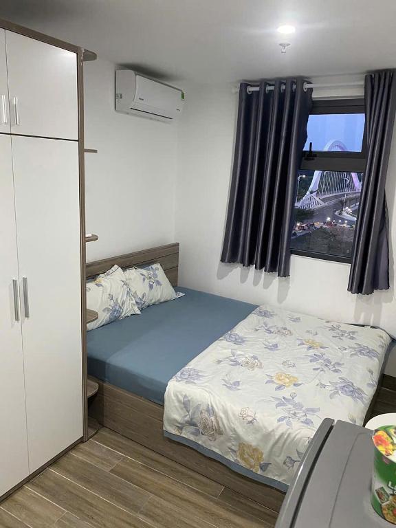 a small bedroom with a bed and a window at Thien Khanh Hotel for rent in Danang