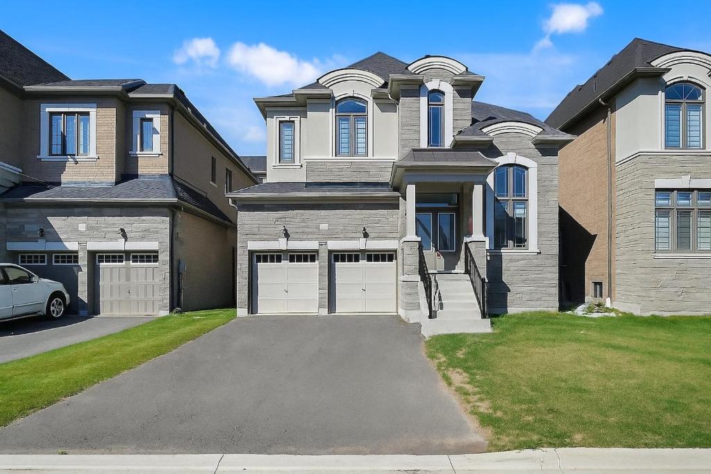 a house with a car parked in front of it at Modern-Detached 5 Bedroom100 Spotless-Sleeps 13 in Caledon East