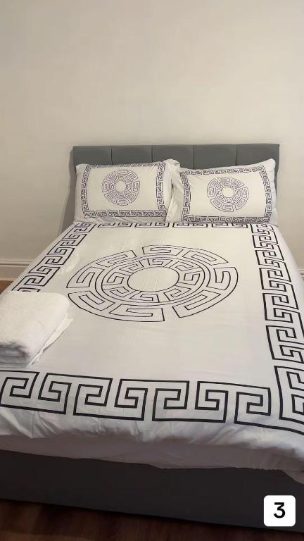 a bed with two pillows on top of it at PLUS Properties Oxford 3 in Stoke on Trent