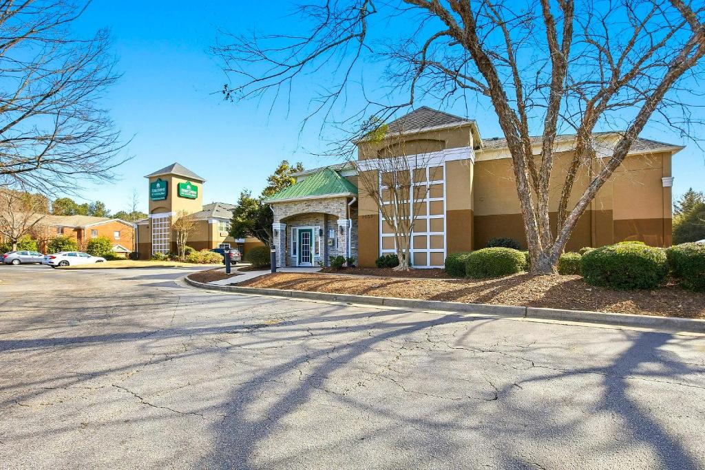 a building on a street in front of a building at HomeTowne Studios by Red Roof Atlanta - Peachtree Corners in Norcross