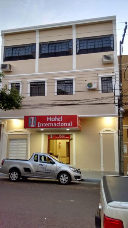 a silver car parked in front of a hotel international at Hotel Internacional in Cianorte