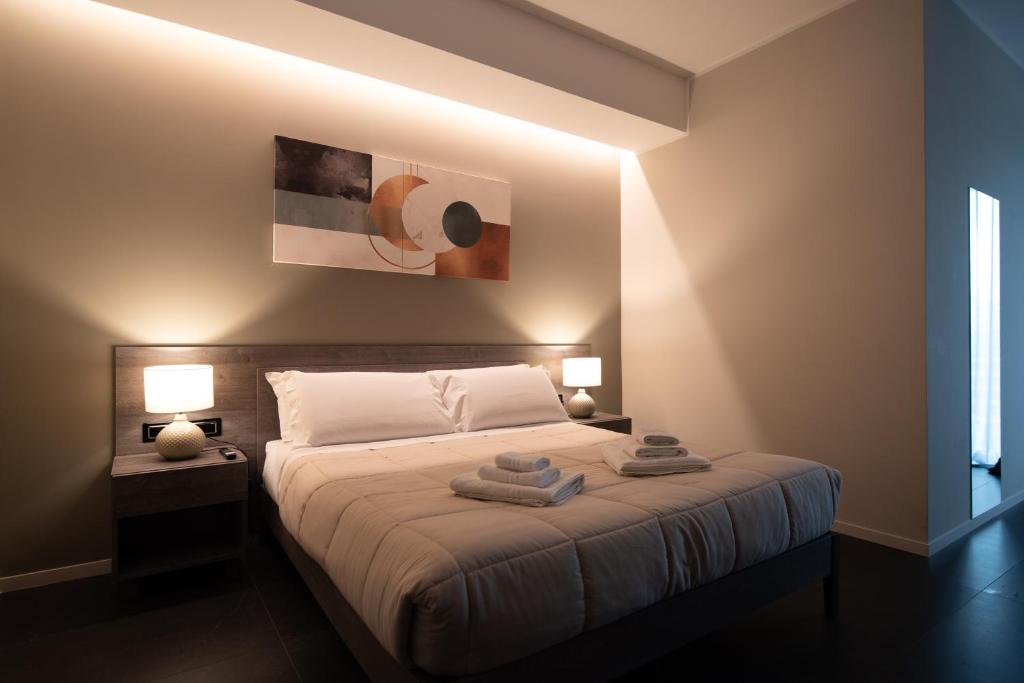 a bedroom with a bed with two towels on it at Palazzo Digiuseppe Rooms in Martina Franca