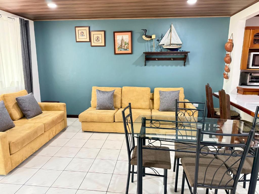 a living room with a couch and a table at Tropical Bliss Pool Wi-Fi BBQ Near Quepos Manuel Antonio in Quepos