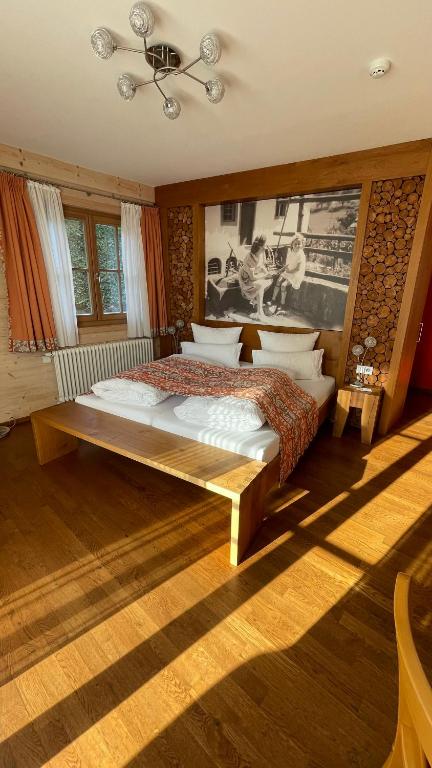 a bedroom with a bed and a chandelier at Neumaier's Hotel in Biberach bei Offenburg