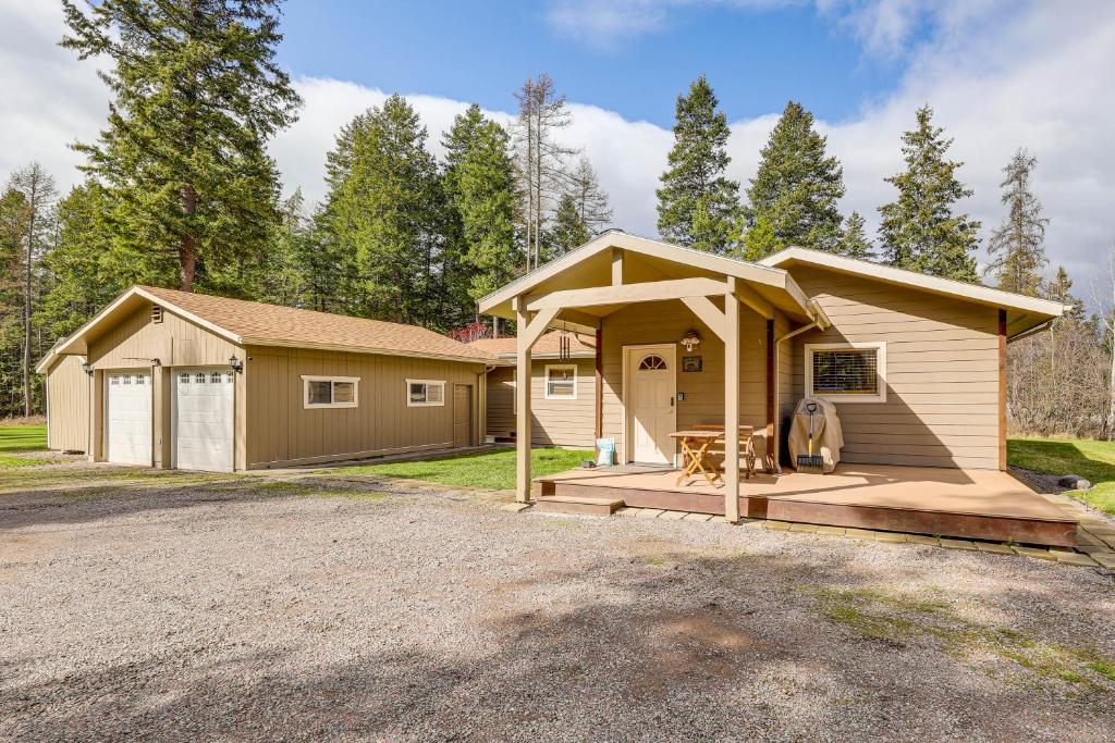 a house with a porch and a garage at Columbia Falls Private Retreat: Pool Table & Deck! in Columbia Falls