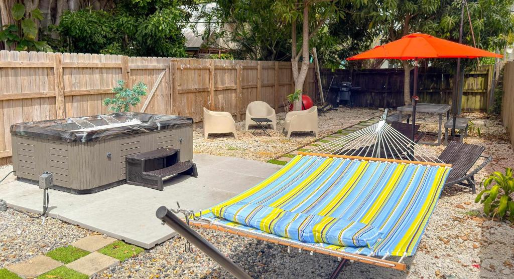 a patio with a hammock and a table and an umbrella at After Hours - Wilton Drive and Jacuzzi in Fort Lauderdale