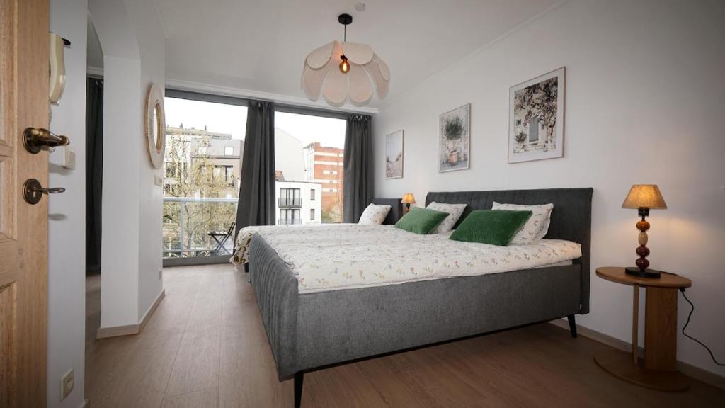 a bedroom with a large bed and a window at Anvers Apartment in Antwerp