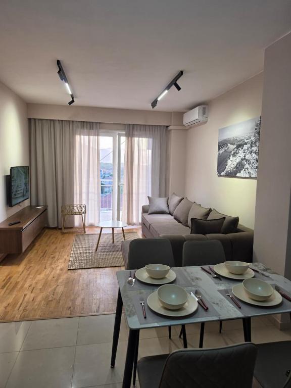 a living room with a couch and a table at Apartment N6 Shkoder in Shkodër