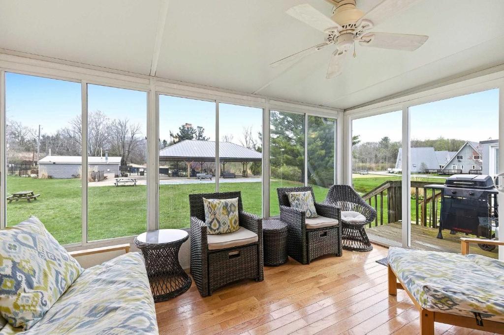 a screened in porch with a couch and chairs at Chalet #44 in Stevensville