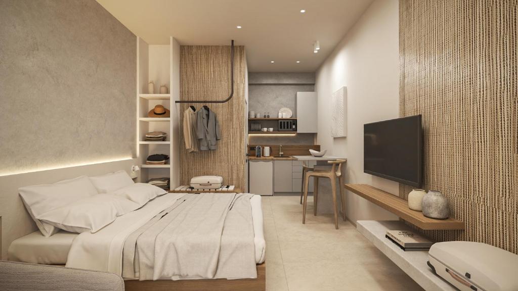 a bedroom with a large bed and a television at NOEMA Fanari in Fanari