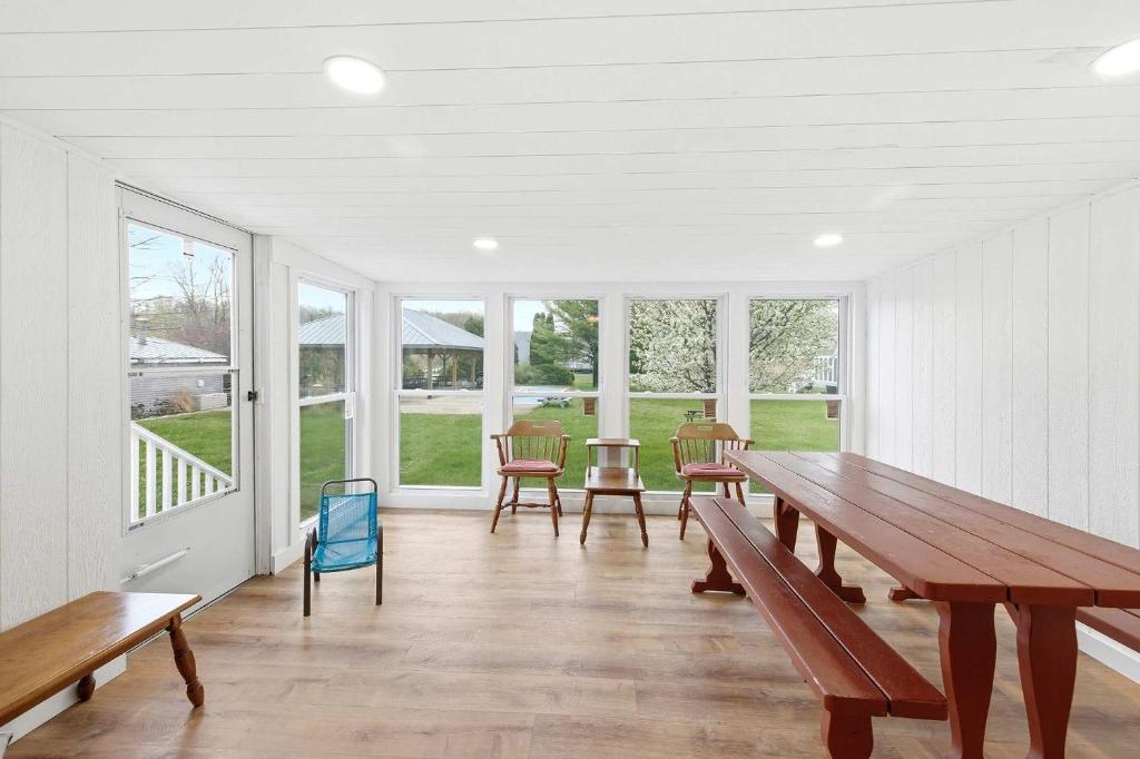 a dining room with a table and chairs and windows at Chalet #39 in Stevensville