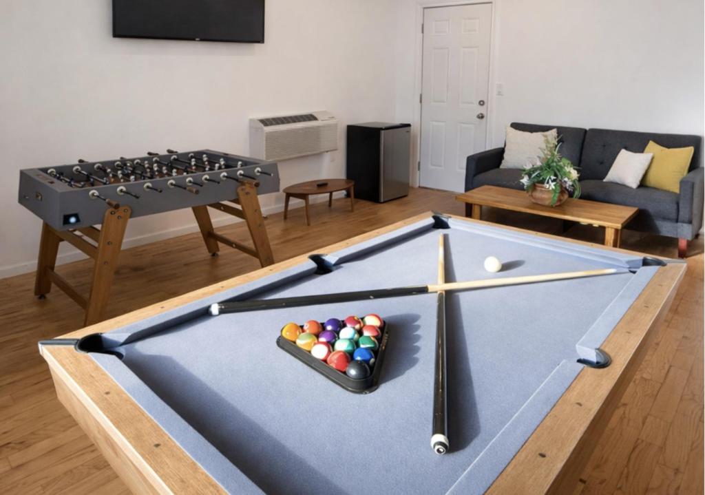 a pool table with balls on it in a living room at Spacious Home with Fire Pit & Game Room Near Yale in Hamden