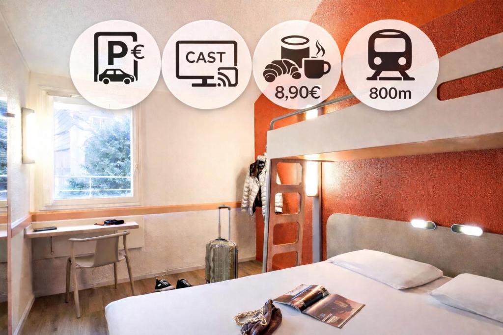 a bedroom with a bed and stickers on the wall at Ibis Budget Lille Gares Vieux-Lille in Lille