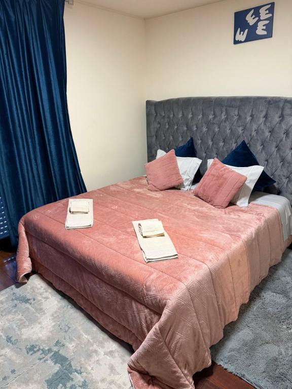 a bedroom with a large bed with two napkins on it at Casa da Lagoa in Geres