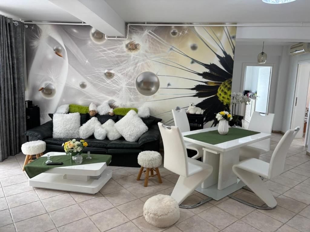 a living room with a couch and a table at Vila Siana in Mamaia