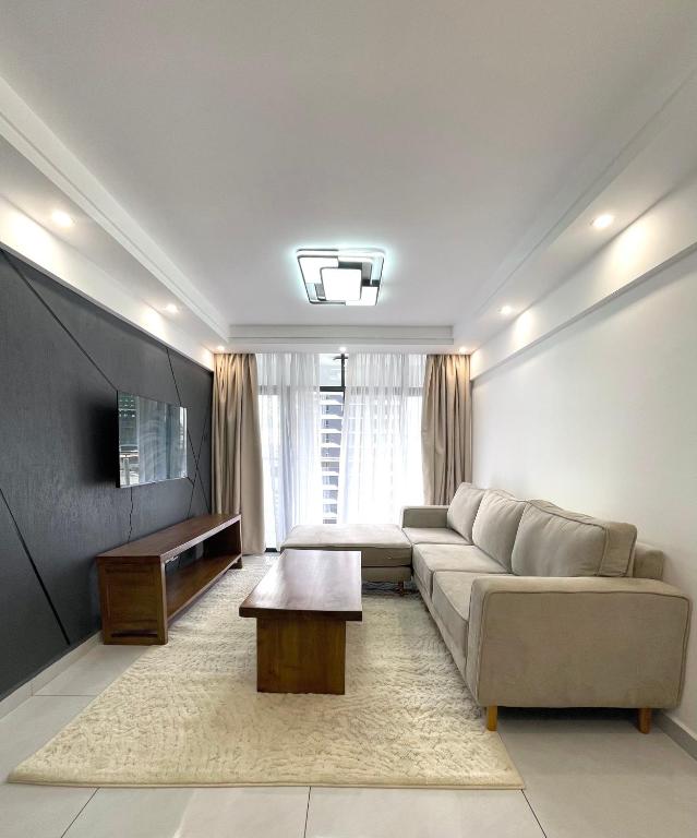 a living room with a couch and a table at Shangri-la residence Westlands-Remote working & gym in Nairobi