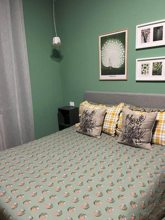 a bedroom with a bed with two pillows at Rosso di Piera Rooms in Arluno