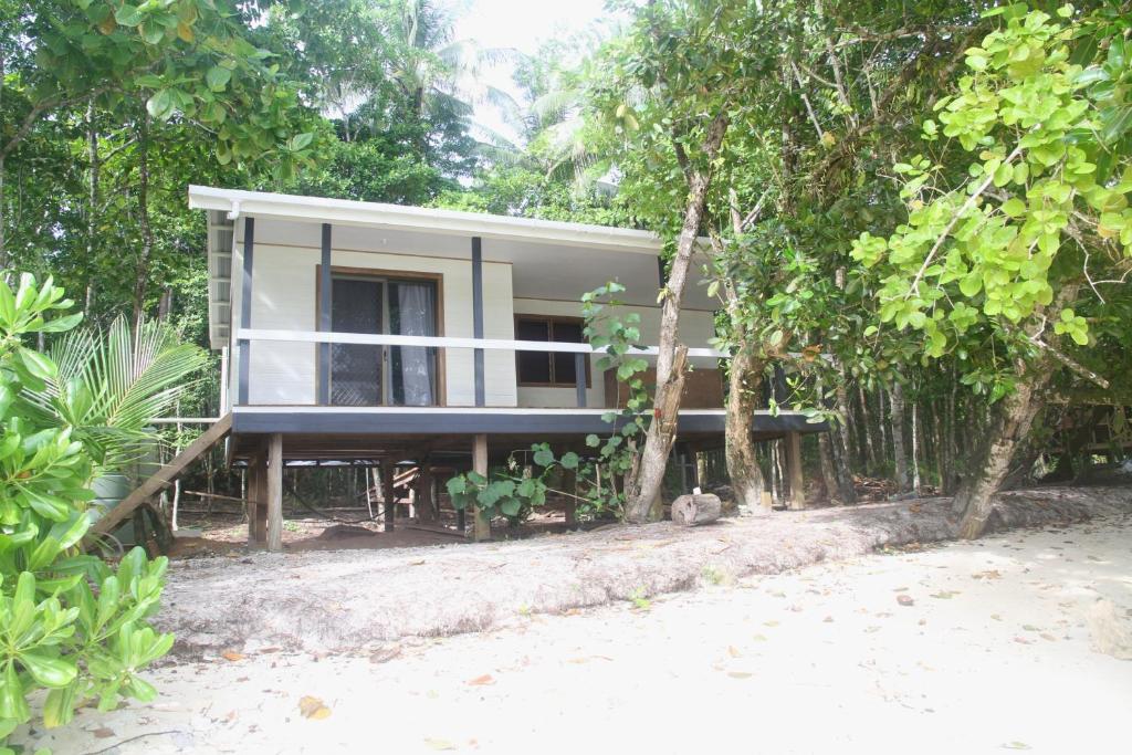 a house in the middle of some trees at Evis Resort at Nggatirana Island in Halisi