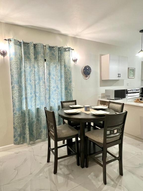 a dining room table and chairs in a kitchen at The Cozy Cot in Discovery Bay