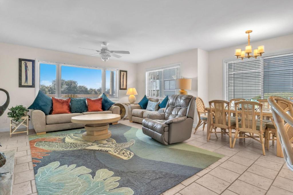 a living room with a couch and a table at #7 Ocean Court by Oak Island Accommodations in Caswell Beach