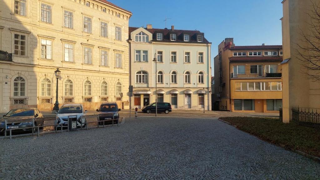 a group of buildings with cars parked in a street at Penzion TGM in Příbram