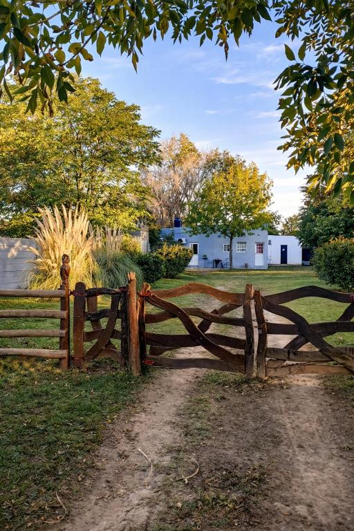 a wooden fence in front of a field at Hospedaje Don Felix in General Acha