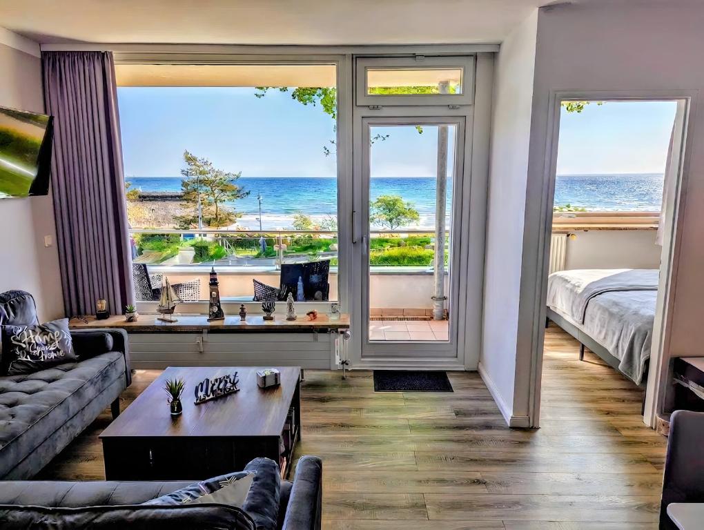 a living room with a view of the ocean at Panorama-Meerblick am Scharbeutzer Strand in Scharbeutz