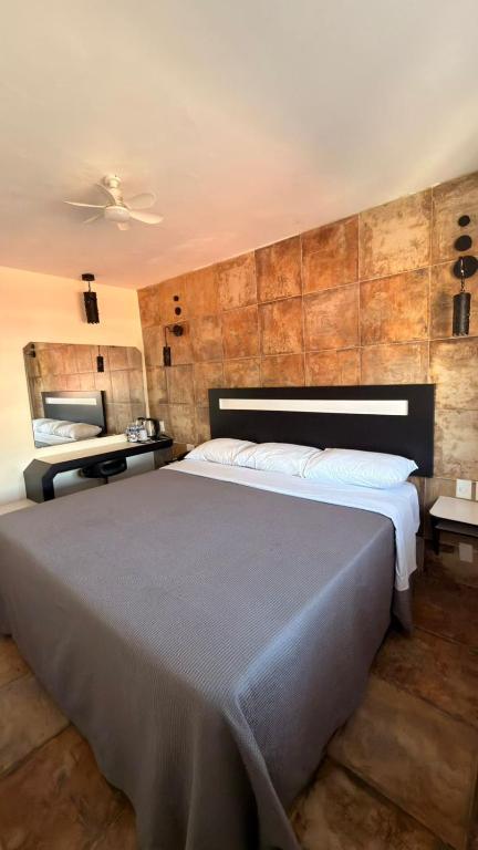 a bedroom with a large bed and a mirror at Hotel Florida, Centro Histórico in Mexico City